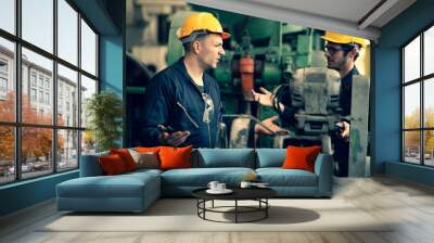 Scene shot of 2 industrial workers feeling upset with the engine machine of the factory, arguing planning, the procedure of work in the factory, concept industrial worker life, working confliction. Wall mural