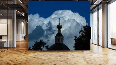 Beautiful Golden Church dome on the background of storm clouds illuminated by the sun. The Church landscape. Dome of an Orthodox Church Wall mural