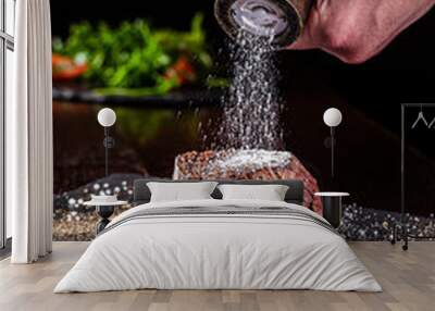 American cuisine. Chef season salt on a juicy beef steak in a restaurant. background image, copy space Wall mural