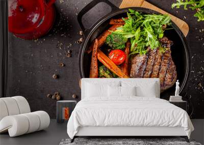 American food concept. Grilled beef steak with grilled vegetables, with carrots, cherry tomatoes, broccoli, in a cast iron pan. copy space Wall mural