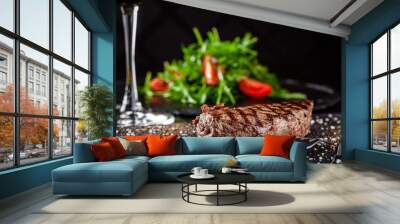 Farm organic food concept. Grilled beef steak with grill. Fried steak on on black slate, on a black background. Wall mural