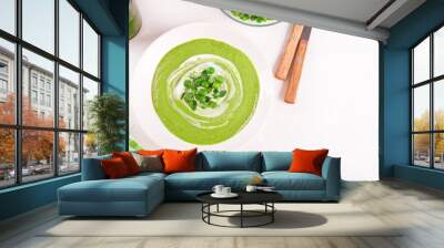 Delicious vegetable soup with potato, broccoli, green pea and spinach on the dinner table Wall mural