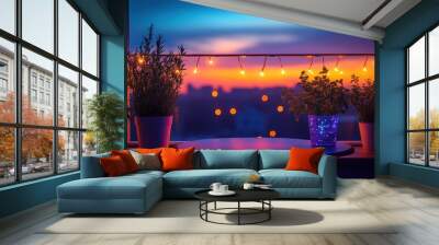 A balcony with potted plants and a table overlooking a city skyline at sunset with fairy lights. Wall mural