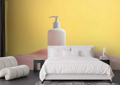 Bottle with cosmetic product on yellow background Wall mural