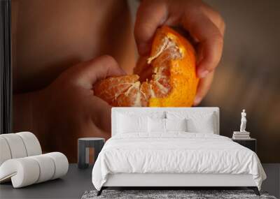 childhood hands peeling a splash orange tangerine Wall mural