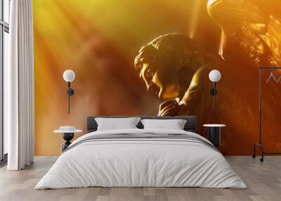 Gold angel in the sunlight. Antique statue. Wall mural