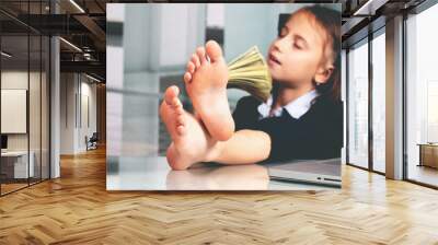 Portrait of very happy cute young business girl counts money profit. Selective focus on bare feet Wall mural