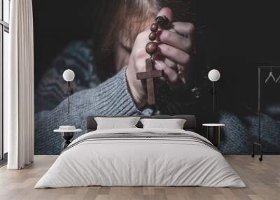 Prayer to God. Portrait of young girl pray with rosary. Faith concept. Selective focus. Wall mural