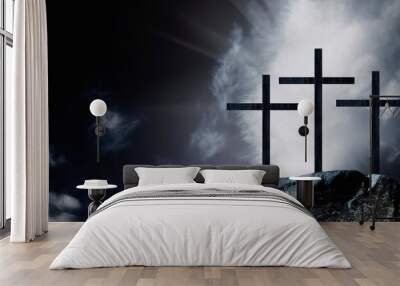 silhouette of three crosses on a rocky hill against dramatic sky background as symbol of the crucifi Wall mural