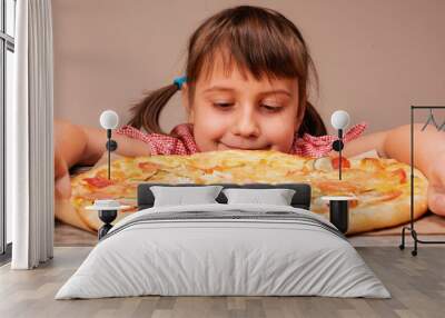 Very happy young beautiful girl enjoys pizza. Horizontal image. Wall mural