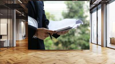 Architect reading documents in office Wall mural