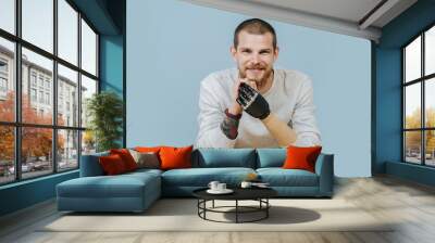 Young Man With Artificial hand is looking forward and smiling at the camera Wall mural