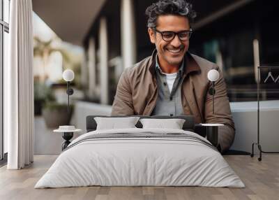 Content professional man using smartphone outside of a modern building. Wall mural