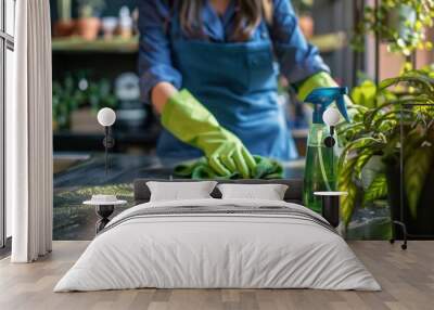 Green Cleaning Concept: Person Wiping Table, Spray Bottle, Plants Wall mural