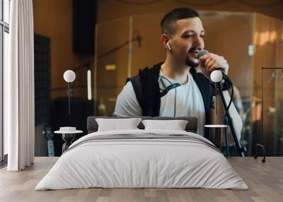 man singing into a microphone in musical rehearsal studio Wall mural