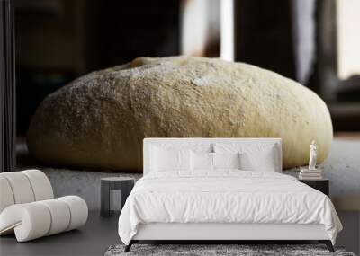 Fresh dough for baking bread on the kitchen table. Wall mural