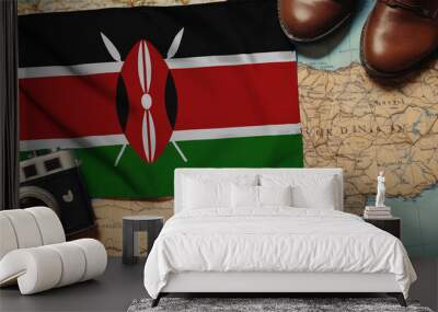 Kenya flag on the map surrounded by camera, shoes. Travel and tourism concept Wall mural