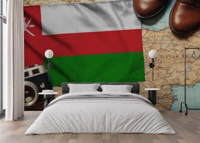 Oman flag on the map surrounded by camera, shoes. Travel and tourism concept Wall mural