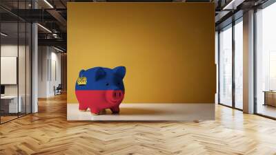 Piggy bank with painting of Liechtenstein flag. The problem is in the economy. Economic crisis. Saving money concept. Wall mural