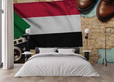 Sudan flag on the map surrounded by camera, shoes. Travel and tourism concept Wall mural