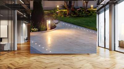 marble tile playground in the night backyard of mansion with flowerbeds and lawn with ground lamp and lighting in the warm light at dusk in the evening. Wall mural