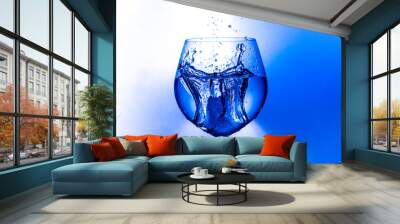  splash of water from a wine glass on a light background Wall mural