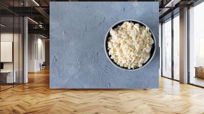 tasty useful fresh cottage cheese, cottage cheese. Homemade white cheese crumbles in a porcelain bowl Wall mural