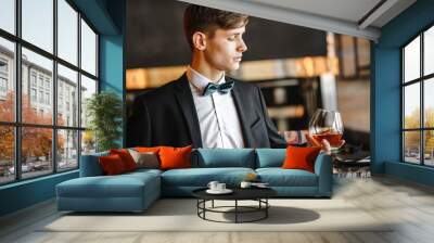 A business man holds a glass of wine Wall mural