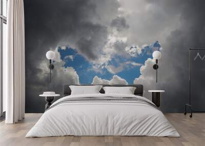 Letter W in the clouds as a heavenly sign, symbol. Wall mural