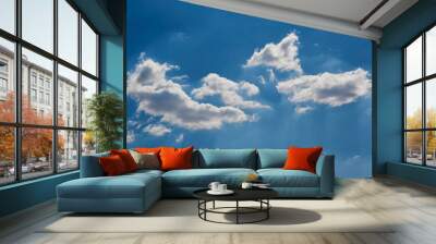 White clouds in sunlight in a blue sky Wall mural