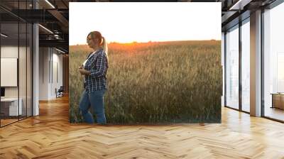 Banner. Agriculture. Two farmers are talking at sunset against the backdrop of a wheat field. Copy space. A couple of farmers are discussing selling grain after the harvest. Wall mural