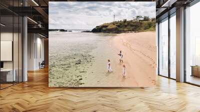 A family walks on Gris Gris beach in southern Mauritius in the Indian Ocean Wall mural