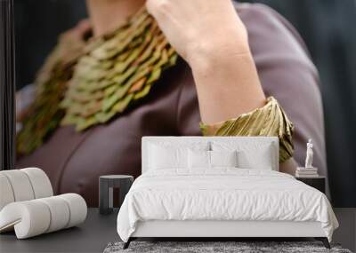 Close-up of a woman's neck ornament and a bracelet made of green leaves. The concept of floristry Wall mural