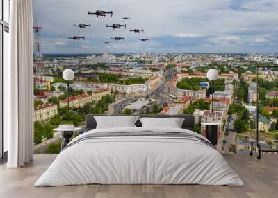 Drones fly over a residential city. Urban landscape with drones flying over it, quadrocopters Wall mural