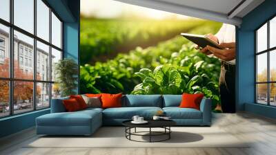 Close Up of a Young farmer using digital tablet inspecting fresh vegetable in organic farm. Agriculture technology and smart farming concept. Wall mural