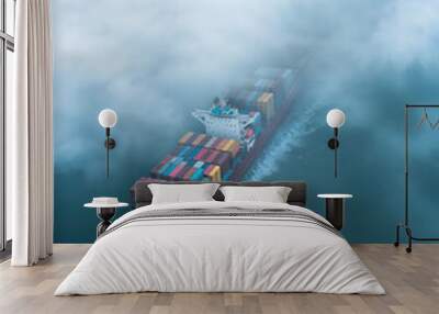 Container ship sailing on the ocean on a foggy day Wall mural