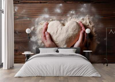 Female hands holding raw dough in heart shape on wooden table. Wall mural