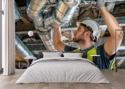 Hvac technician installing air duct system in building Wall mural