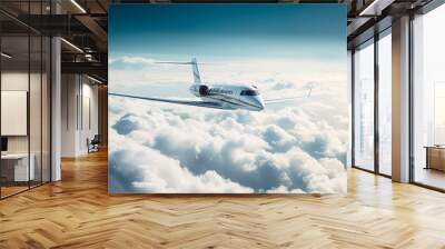 Private jet flying over the earth. Empty blue sky with white clouds at background. Business Travel Concept. Horizontal. Wall mural