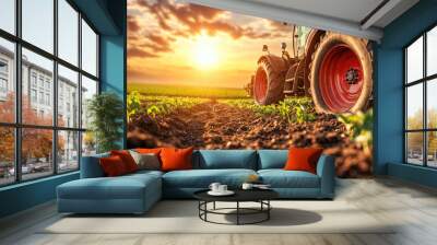 Red tractor working on the field at sunset with dramatic sky Wall mural