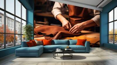 Tailor cobbler hold different rolls natural brown leather, working with textile in workshop	
 Wall mural