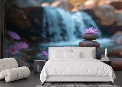 Woman holding stack of zen stones with purple flowers by waterfall Wall mural