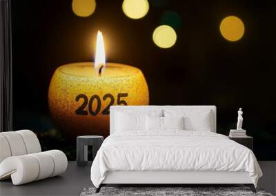 A lit candle with the number 2025 written on it Wall mural