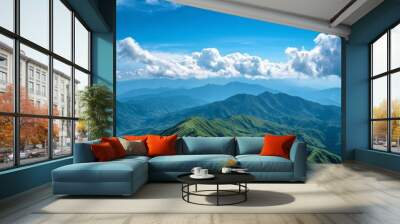 Mountainous ridges with green terrains and blue sky Wall mural