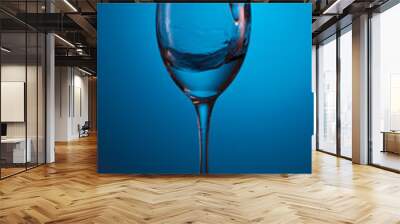 splash of water in a glass on a beautiful gradient blue background Wall mural