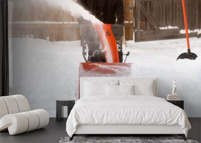 A portable snow blower powered by gasoline. Snow removal in winter. Wall mural