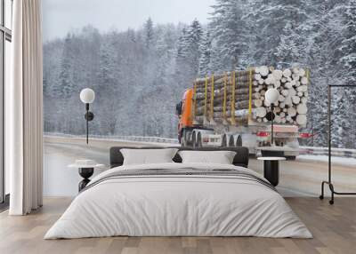 Logging truck on the highway in winter. Wall mural