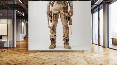 Combat-ready trousers with accessories displayed on a neutral backdrop for tactical preparation Wall mural