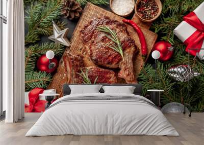 Christmas dinner for two, grilled beef steak ribeye, herbs and spices on a stone table with a Christmas tree and New Year's toys Wall mural