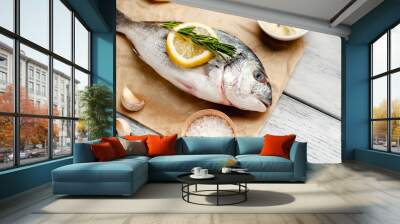 Dorado fish with spices and olive oil on a wooden table.  Wall mural